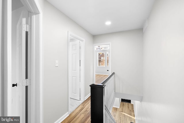 corridor with light hardwood / wood-style floors