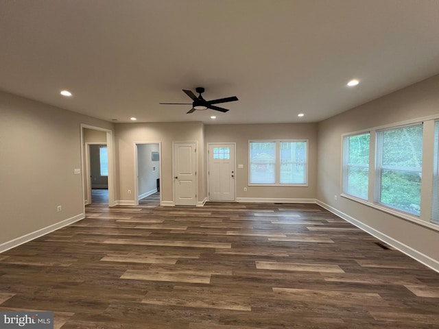 interior space with ceiling fan and dark hardwood / wood-style flooring