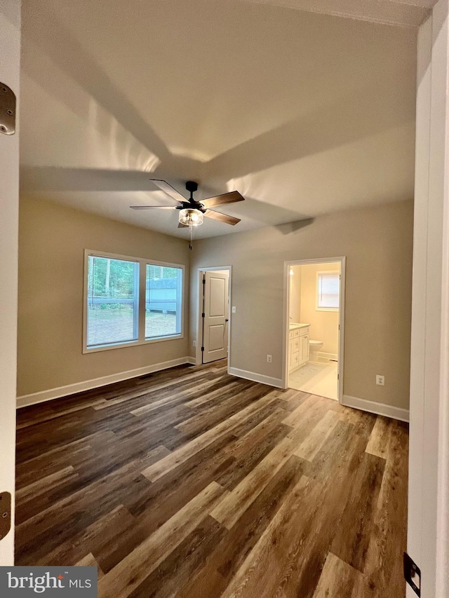 spare room with ceiling fan and dark wood-type flooring