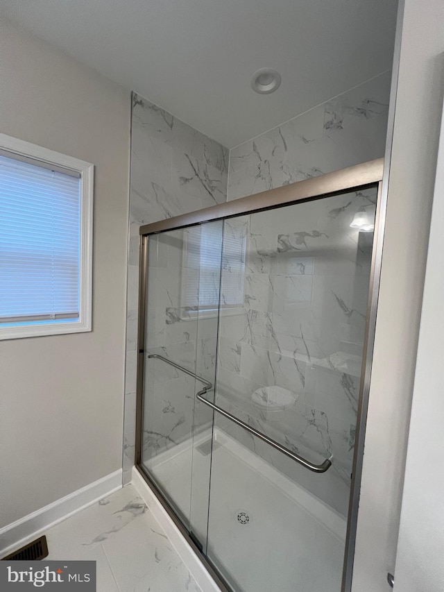 bathroom featuring an enclosed shower