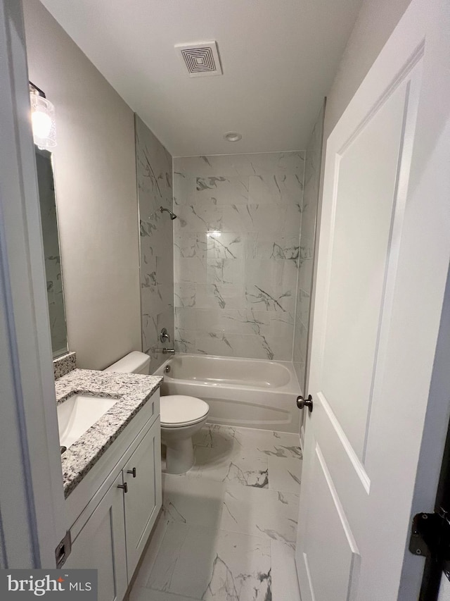 full bathroom with vanity, tiled shower / bath combo, and toilet