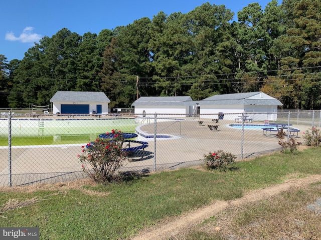 view of pool with a patio area, an outbuilding, and a yard