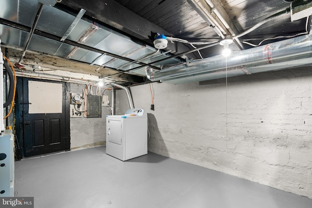 basement with electric panel and washer / dryer