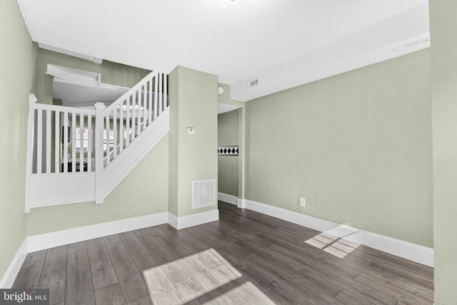 empty room with dark hardwood / wood-style flooring