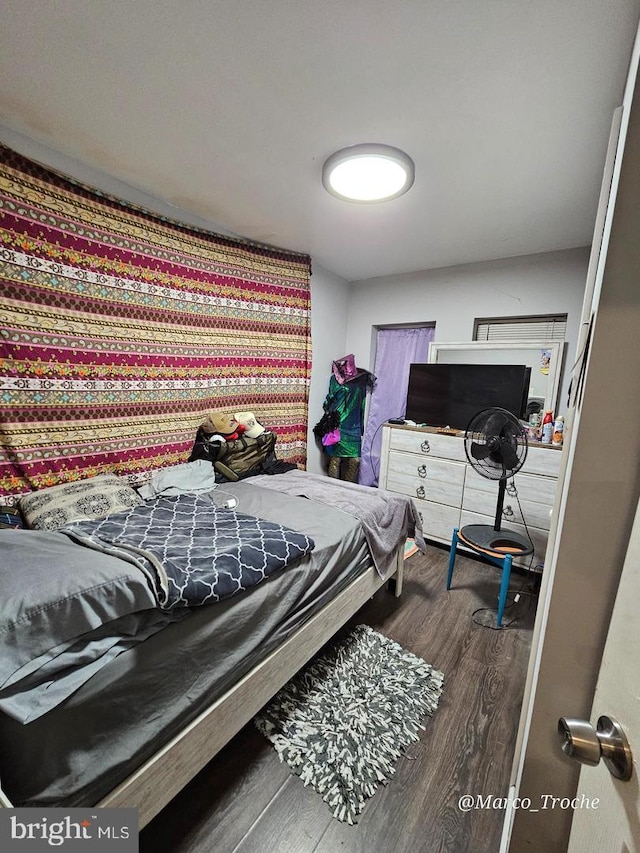 bedroom with dark wood-type flooring