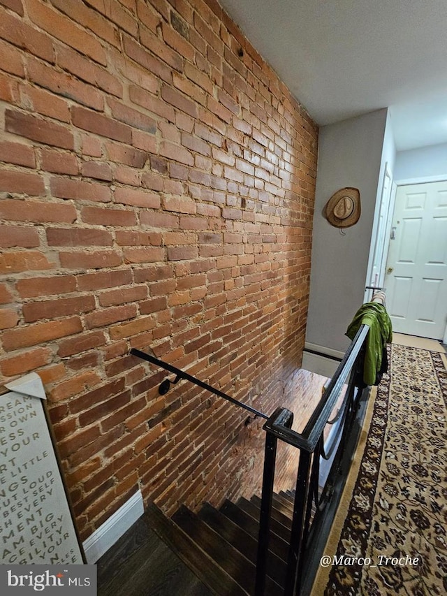 stairs featuring brick wall