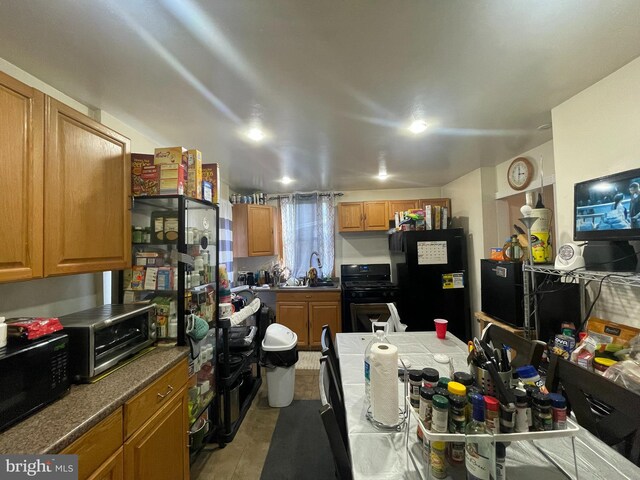 kitchen featuring black appliances and sink