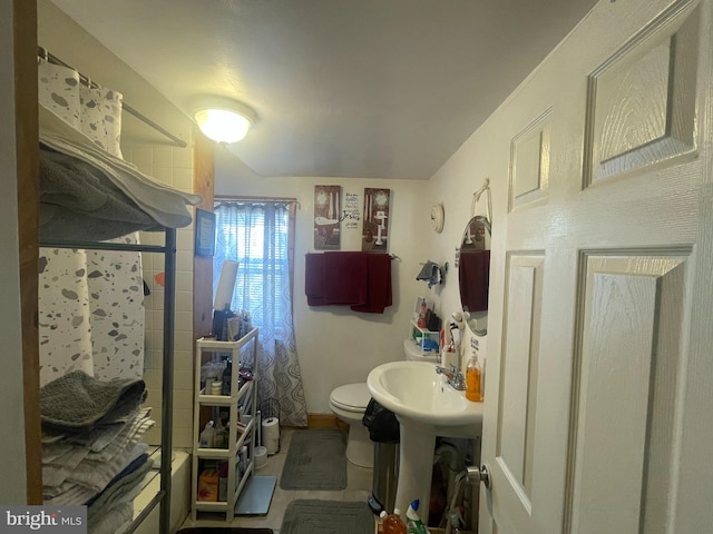 bathroom featuring shower / tub combination and toilet