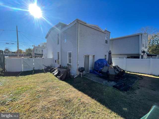 back of house with a lawn