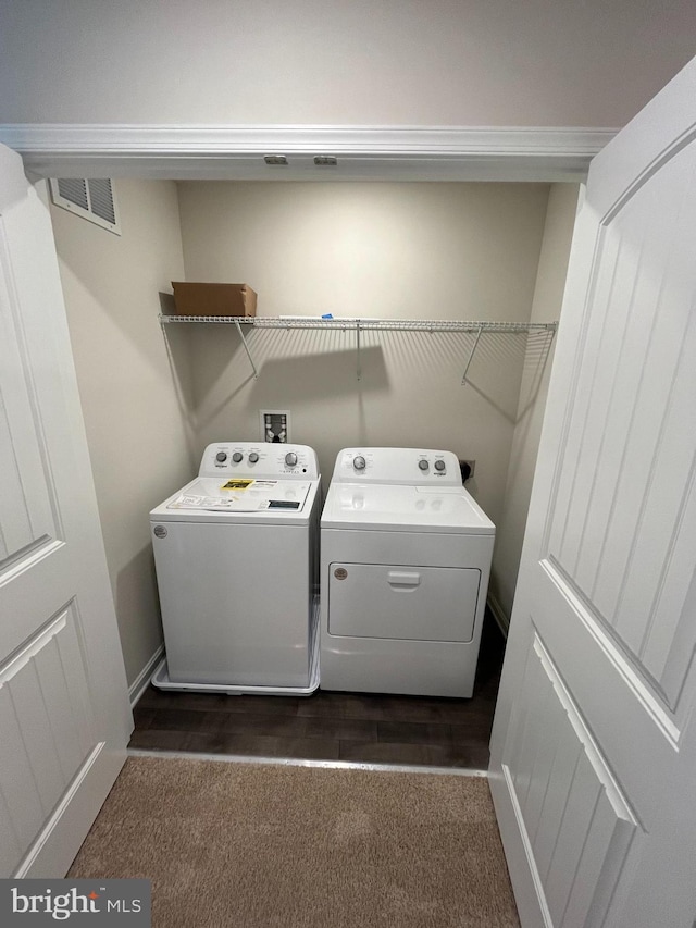 laundry area featuring dark hardwood / wood-style flooring and independent washer and dryer