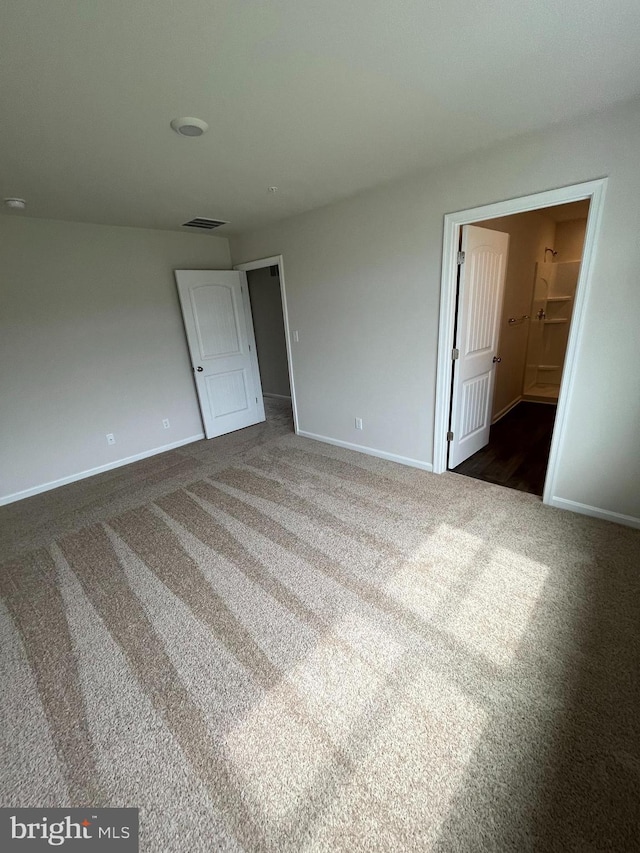 unfurnished room with dark colored carpet