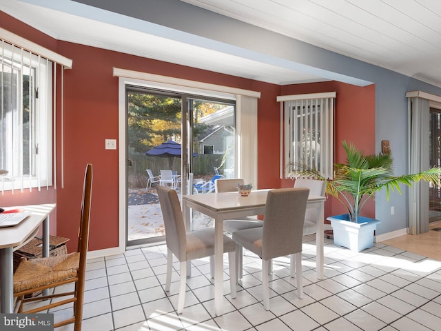 tiled dining space featuring ornamental molding