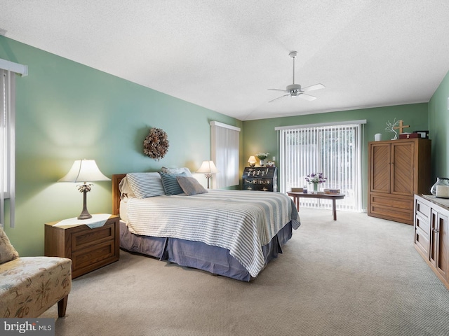 carpeted bedroom with a textured ceiling and ceiling fan