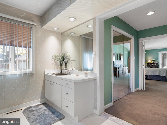 bathroom with vanity and a textured ceiling