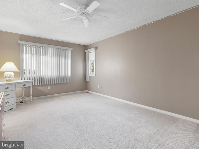 unfurnished room with a textured ceiling, light colored carpet, and ceiling fan