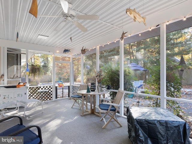 sunroom / solarium featuring ceiling fan