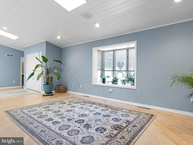 sitting room with wood ceiling, wood-type flooring, vaulted ceiling, and crown molding