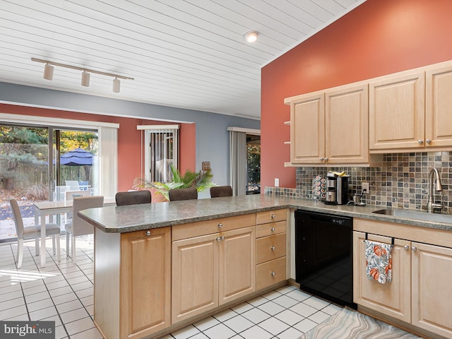 kitchen featuring vaulted ceiling, dishwasher, kitchen peninsula, sink, and backsplash