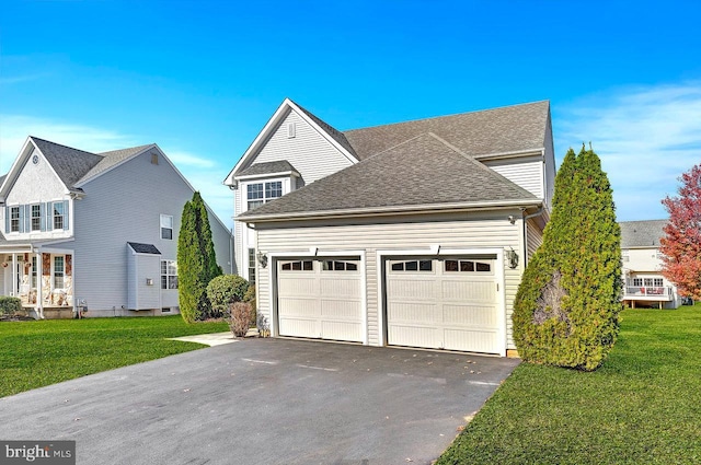 view of front of house with a garage and a front yard