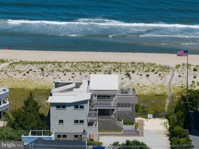 bird's eye view with a water view and a beach view