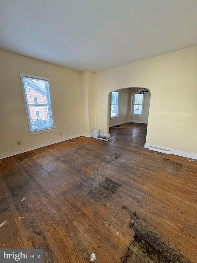 unfurnished living room featuring dark wood-type flooring