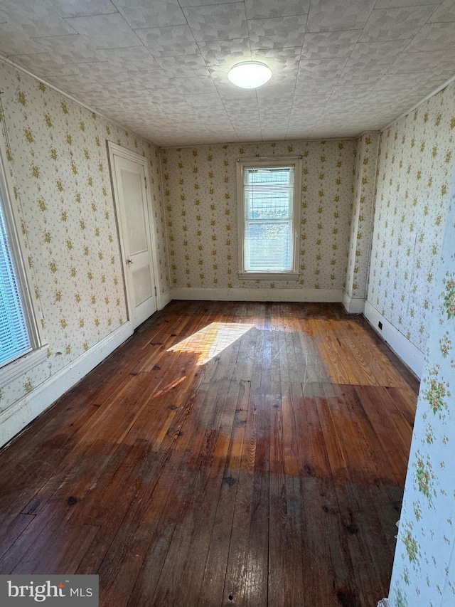 spare room featuring dark wood-type flooring