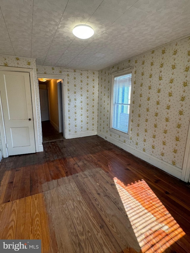 empty room with dark hardwood / wood-style floors