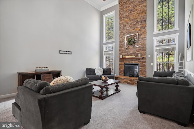 living room with a fireplace, a towering ceiling, light colored carpet, and ornamental molding