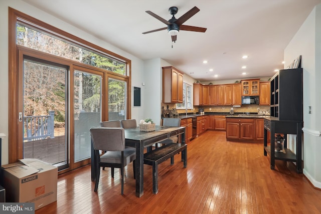 dining room featuring ceiling fan, light hardwood / wood-style floors, and sink