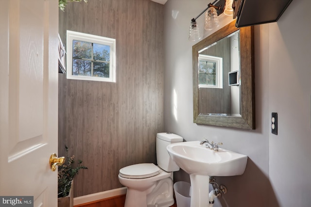 bathroom featuring hardwood / wood-style floors, a healthy amount of sunlight, and toilet