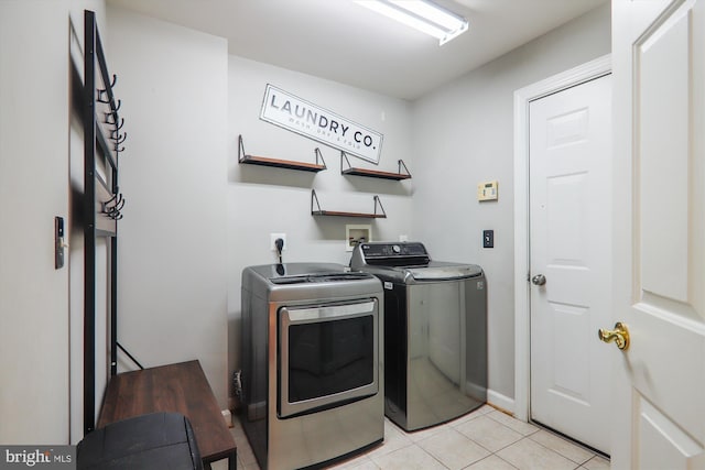 laundry room featuring independent washer and dryer and light tile patterned floors