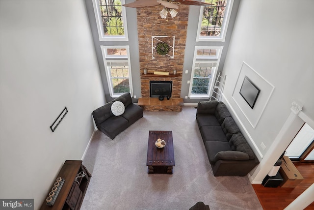 living room with wood-type flooring, a high ceiling, and a wealth of natural light