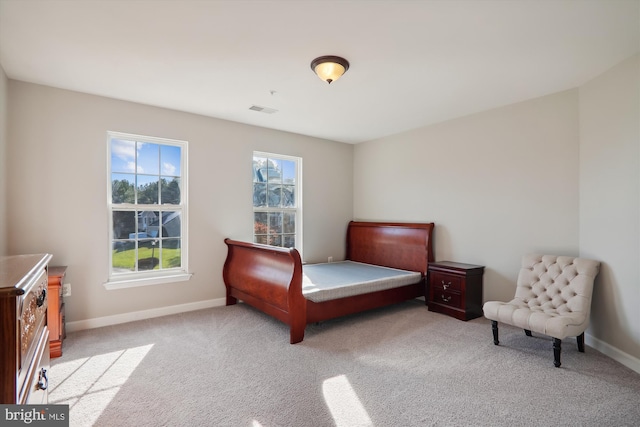 bedroom featuring light colored carpet