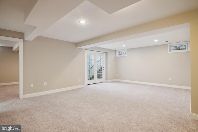 basement with light carpet and french doors