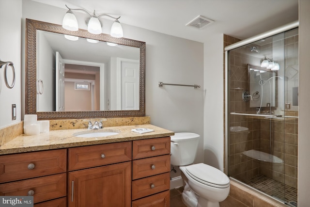 bathroom with vanity, toilet, and an enclosed shower