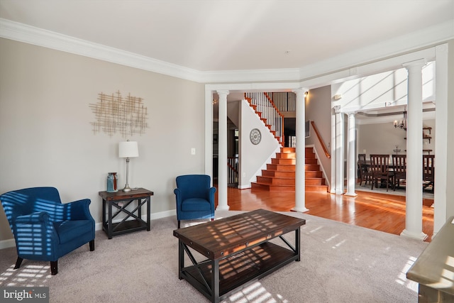 living room featuring hardwood / wood-style floors, ornamental molding, and a notable chandelier