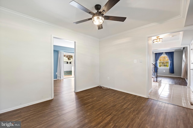 spare room with ornamental molding, dark wood-type flooring, and ceiling fan