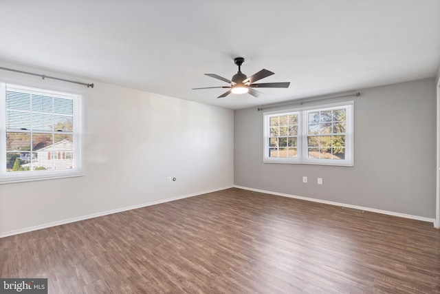 empty room featuring ceiling fan and dark hardwood / wood-style floors