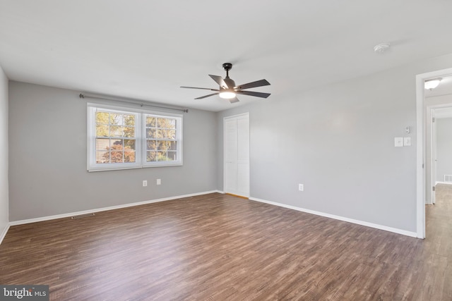 unfurnished room with ceiling fan and dark hardwood / wood-style floors