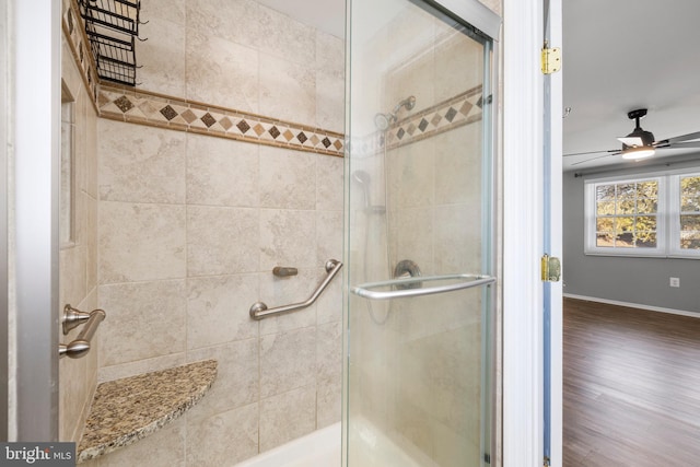 bathroom featuring an enclosed shower, hardwood / wood-style flooring, and ceiling fan