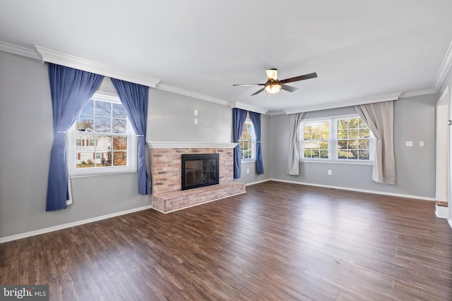 unfurnished living room with dark wood-type flooring, ceiling fan, a fireplace, and ornamental molding