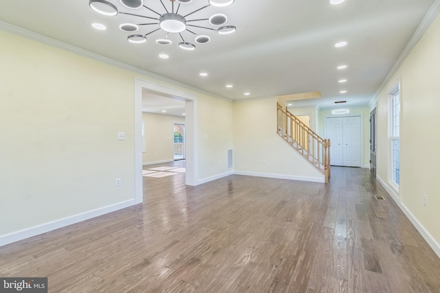 12700 Macduff Dr, Fort Washington, MD 20744 - unfurnished living room with ornamental molding, stairway, wood finished floors, a chandelier, and recessed lighting