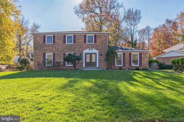 12700 Macduff Dr, Fort Washington, MD 20744 - colonial inspired home featuring french doors, a front yard, and brick siding