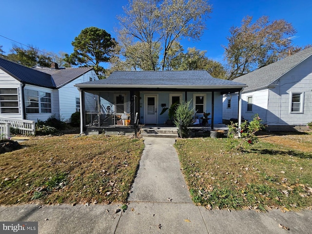 bungalow with a front lawn and a porch