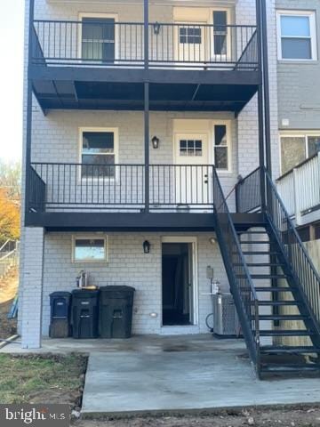 back of house with central AC and a patio area