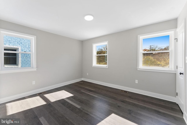 empty room with dark hardwood / wood-style floors