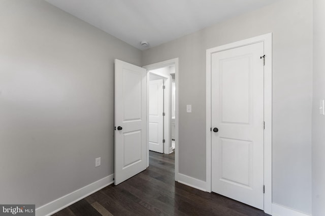 unfurnished bedroom featuring dark hardwood / wood-style floors