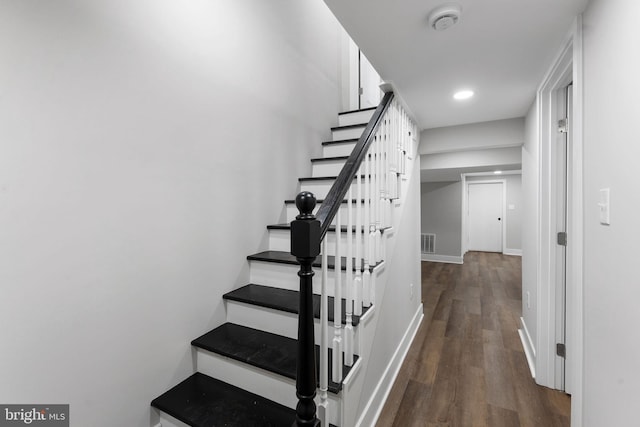 stairs featuring wood-type flooring