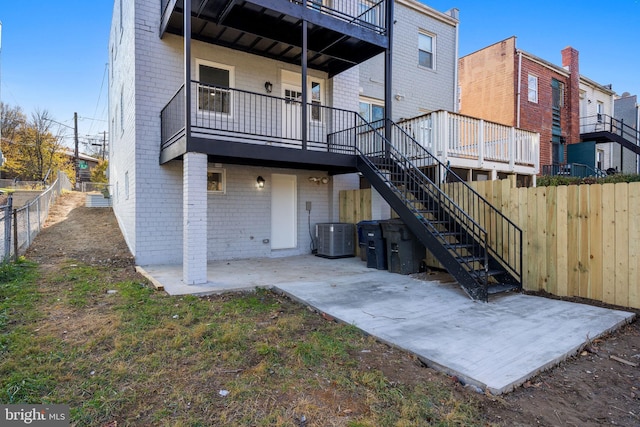 rear view of house with cooling unit and a patio area