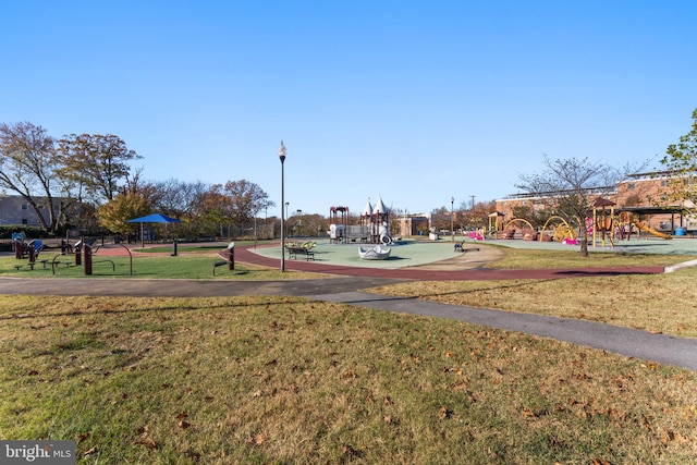 view of home's community featuring a playground and a lawn